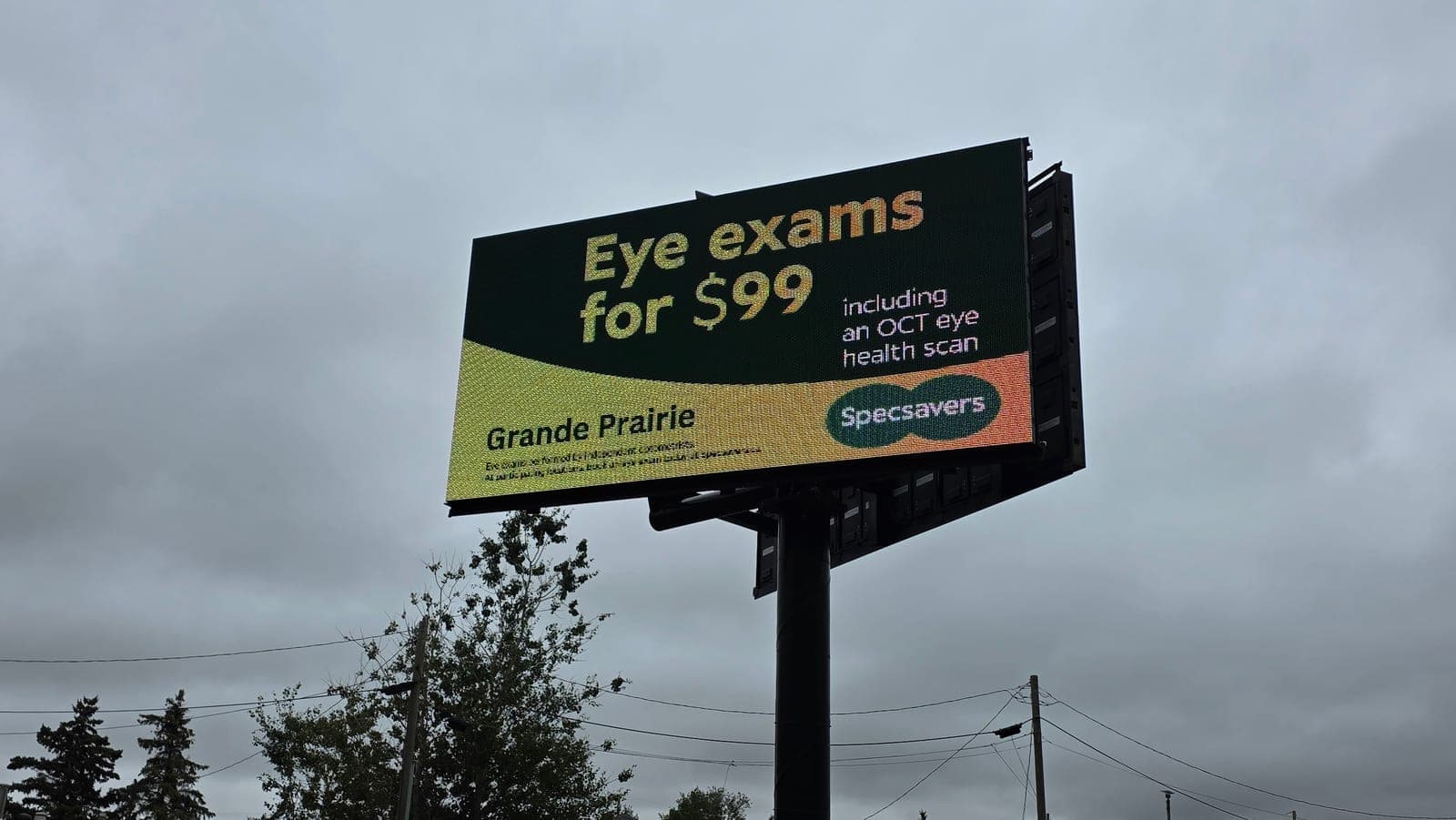 A real advertiser's ad running on the MileAds board on Highway 43, promoting an offer to Grande Prairie traffic
